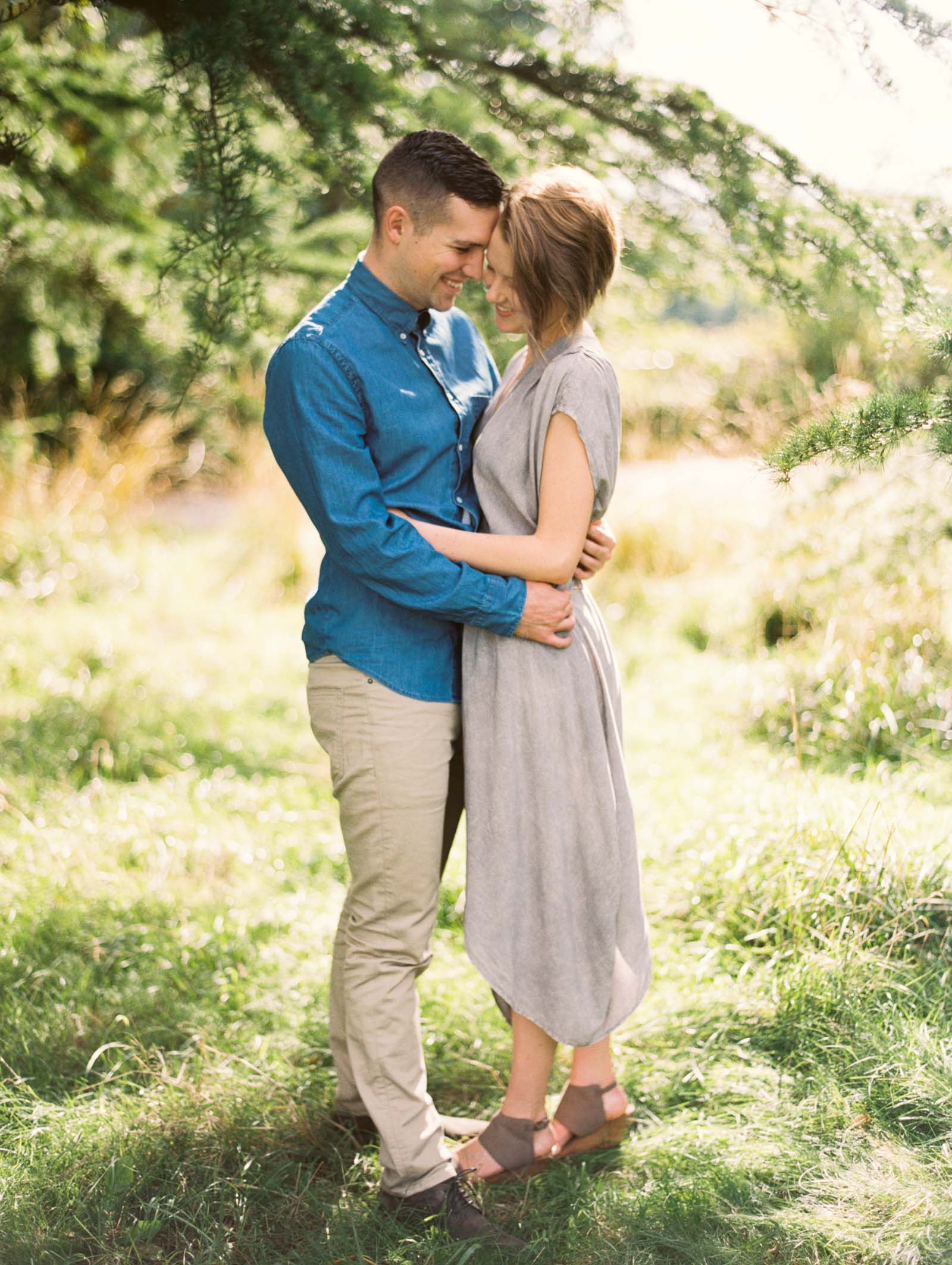 A romantic embrace at discovery park captured on film by top Seattle Engagement Photographer Anna Peters