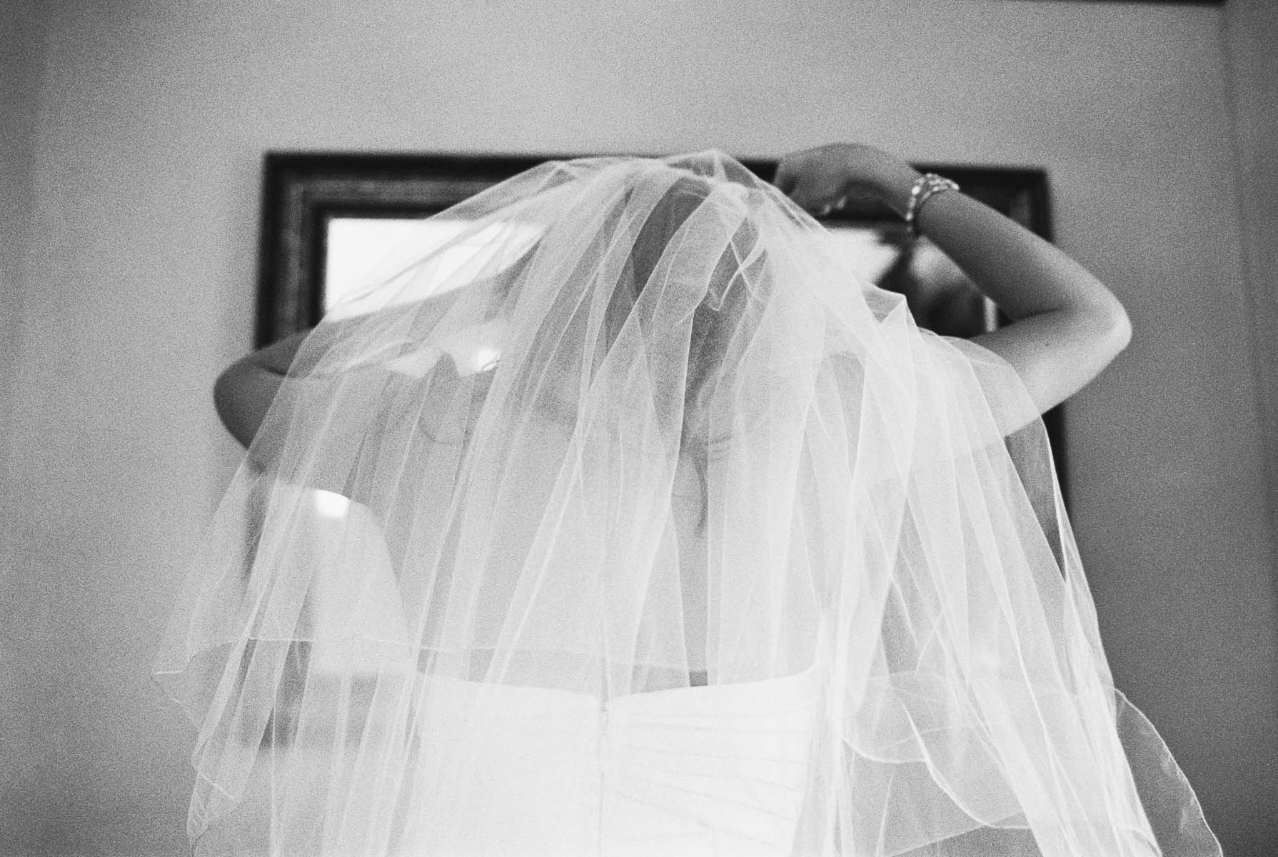 Bride adjusting her veil at Beacon Hill Events with Spokane Wedding Photography by Anna Peters