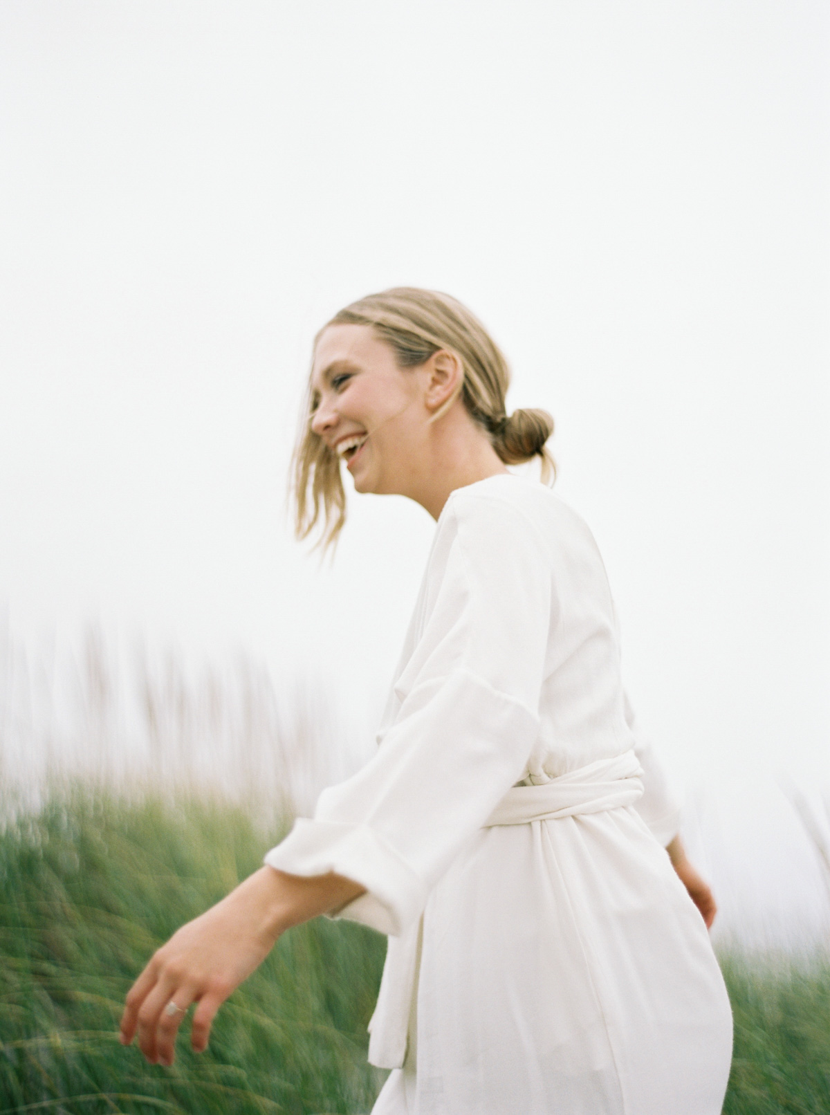 Portrait of woman in white dress near sand dunes