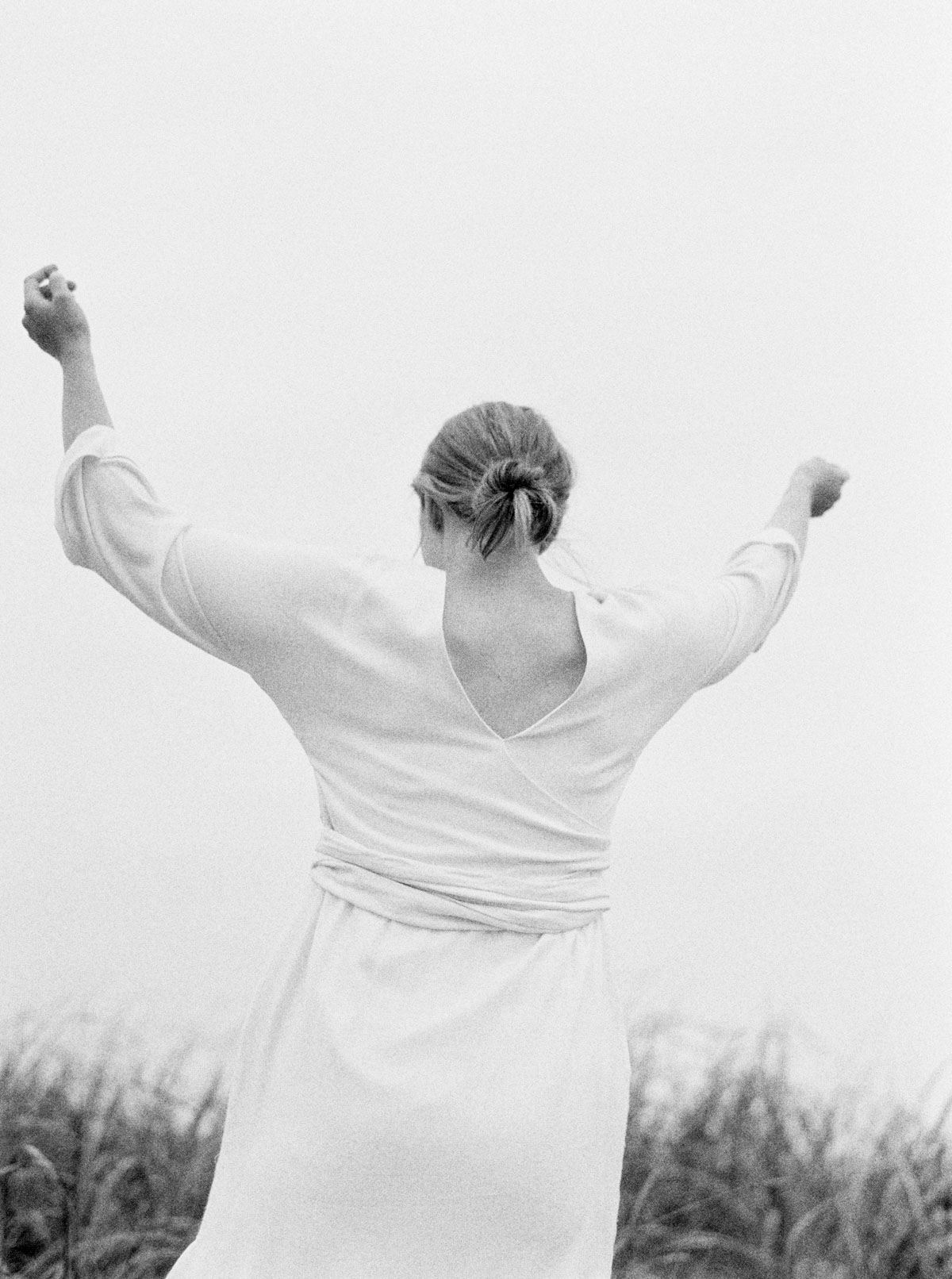 Portrait of woman in white dress near sand dunes